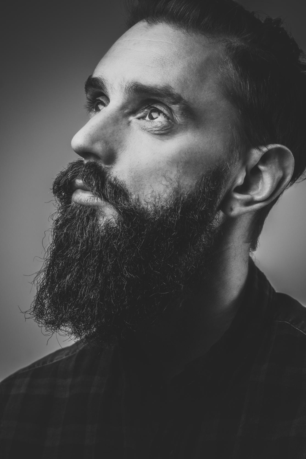 closeup-photo-shoot-of-pensive-man-with-beard-black-and-white-photo-with-low-contrast